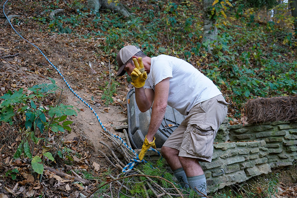 A rope helps Caregivers navigate the steep hillside.